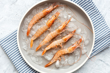 Fresh raw prawns prepared for cooking with pepper, lemon and parsley