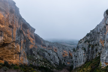 A picturesque landscape view of a cliff range in the valley of Rio Vero (Alquézar, Huesca, Spain) in the Spanish Pyrenees on a cold cloudy winter morning