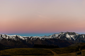 A picturesque landscape view of the snow capped French Pyrenees mountain range early in the morning at dawn before sunrise (Col de Soum)