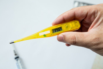 digital thermometer in hand, high temperature