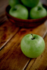 green apples on the table after rain