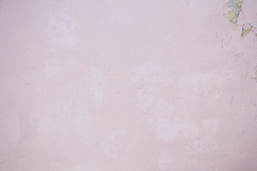 Pink concrete wall with chipped and scratches. Aged texture and background