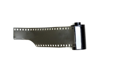 vintage photographic film with perforations in cassette on white background isolate