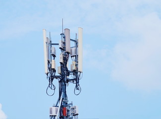 Telecommunication tower of 4G and 5G cellular. Macro Base Station. Wireless Communication Antenna Transmitter. Telecommunication tower with antennas against blue sky background.