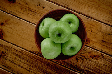 green apples on the table after rain