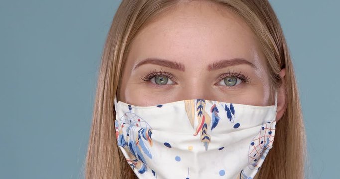 Close up portrait of beautiful woman wearing stylish face mask. Protection against viruses pollution
