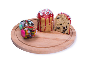 Easter cakes with raisins lie on a round, wooden board, white background