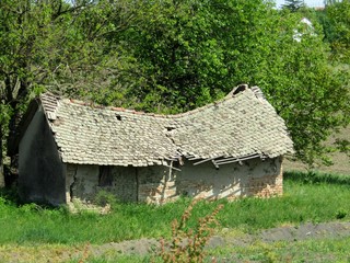 An old abandoned house in a rural area has just collapsed