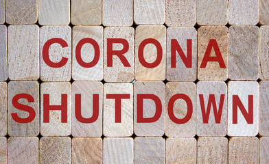 Wooden blocks form the words 'corona shutdown'. Beautiful wooden background. COVID-19 Pandemic Coronavirus concept.