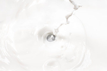 close up of white splashing and swirling delicious milk