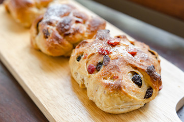 Raisin bread and cranberries placed on a wooden table