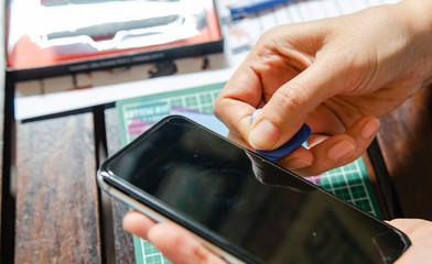 Electronic technicians who are repairing mobile phone batteries.