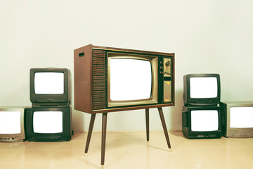 Retro old televisions with cut out screen on floor in the room, vintage style photo