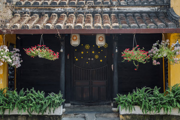 Fototapeta na wymiar traditional house with brown doors and Chinese lanterns in Hoi an old town. world heritage site. Vietnam