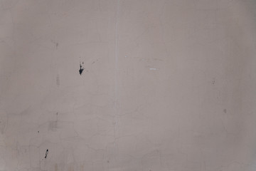 Background texture of the old plastered wall of a house in beige color.