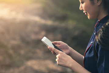 Woman hands using a smartphone outdoors.