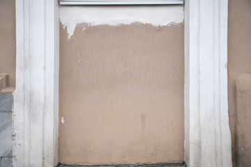 Background texture of the old plastered wall of a house in beige color.