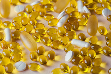 Natural vitamins and supplements on pink background