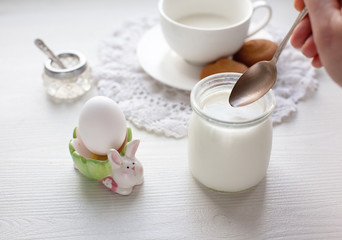 Fototapeta na wymiar Healthy breakfast served on white dresser scarf with hand holding silver spoon
