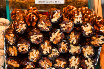Cevizli sucuk made by dipping a string with walnuts into a grape molasses mixture