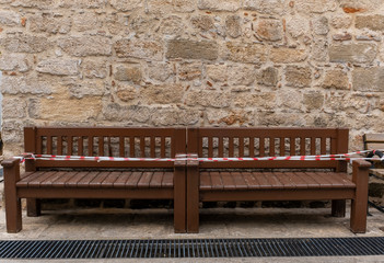 Bench in front of brick wall no sitting for virus