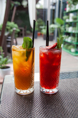 cocktail in the bar. Sea ​​buckthorn and strawberry lemonades summer terrace in restaurant