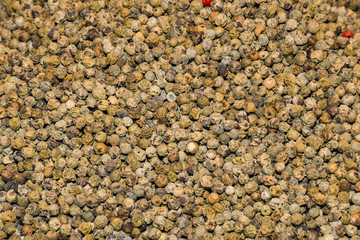 Mixed peppercorns background. Different colored peppercorns, close up.