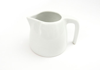 Mini white porcelain milk jug isolated on white background. High quality handmade ceramics. Elevated view
