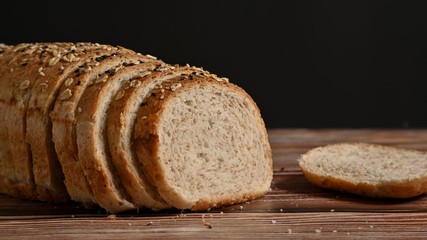 Close up. Slice whole grain bread on the wooden table.
