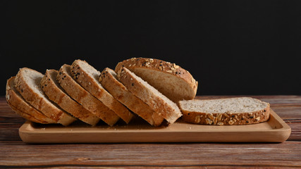 Slice wholewheat bread on wood table.