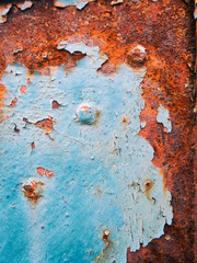 Close up of a rusty and peeling iron gate detail