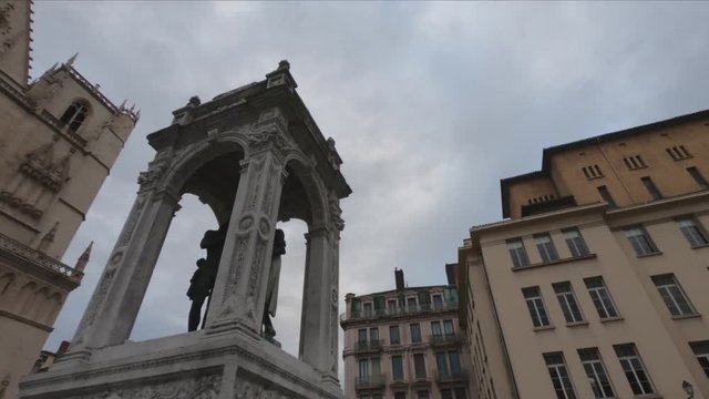 PAN SLOW MOTION - The fountain of Saint John the Baptist and  the front elevation of the Lyon Cathedral (Cathedrale Saint-Jean-Baptiste de Lyon) in the background.