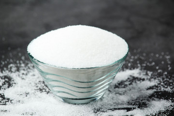 A glass bowl with white sugar