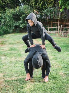 Children Playing Leapfrog In The Garden