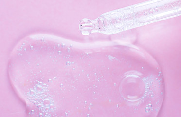Liquid gel or serum on pink isolated background