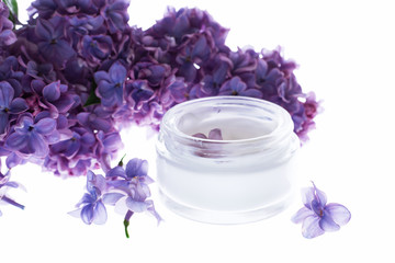 Obraz na płótnie Canvas Face and body skin care. cosmetic cream in white tubes with sprigs of lilac flowers. Spa treatments for home care. Home rejuvenation and moisturizing
