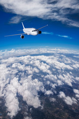 Fototapeta na wymiar Plane Passing Through Clouds