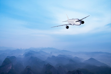 Fototapeta na wymiar airplane flying over mountains 