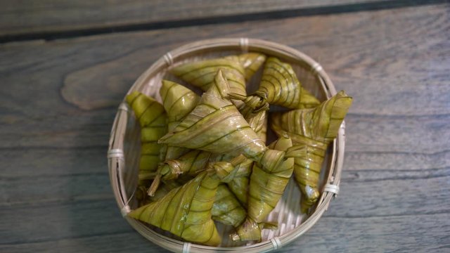 Cinematic shot of ketupat palas, a traditional malay rice dumpling served during eid