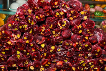 Cevizli sucuk made by dipping a string with walnuts into a grape molasses mixture