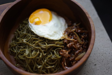 Green Noodle in a Wooden Bowl