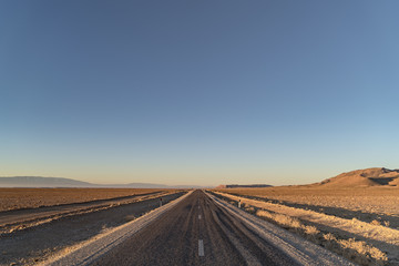Fototapeta na wymiar road at dawn in the Sahara desert in North Africa