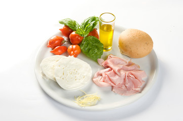  ingredients for a sandwich with mozzarella, cooked ham, cherry tomato, basil and oil on a white background to be cut out