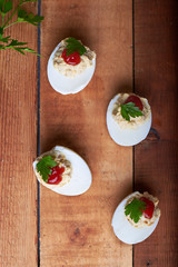 close-up of some hard-boiled stuffed eggs on a rustic table