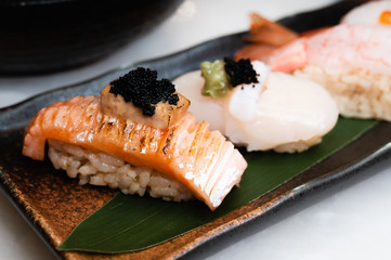 Salmon sushi with foie gras and caviar on top