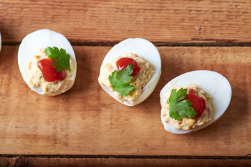 close-up of some hard-boiled stuffed eggs on a rustic table