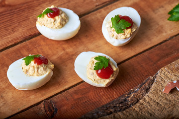 close-up of some hard-boiled stuffed eggs on a rustic table