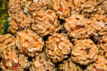 Turkish fruit and nut balls candy. Scattered pistachio and almond nuts