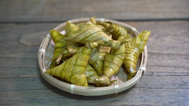 Cinematic shot of ketupat palas, a traditional malay rice dumpling served during eid