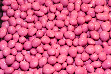 Chocolate covered glazed nuts and seeds, full frame, isolated background
